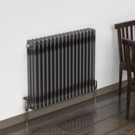 A 600mm x 785mm Horizontal 3 Column Radiator in a Bare Metal Lacquer finish with black nickel traditional valves within a living room setting.
