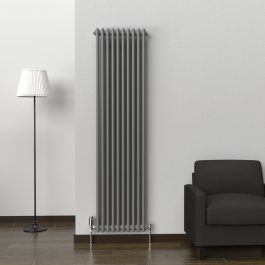 A 1800mm x 470mm Vertical 2 Column Radiator in an Anthracite finish with chrome valves within a living room setting.
