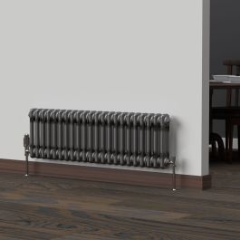 A 300mm x 1010mm 2-Column Horizontal Radiator in a Bare Metal Lacquer finish with a chrome thermostatic valve in a living room setting.

