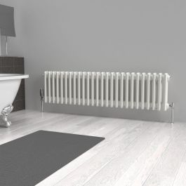 A 300mm x 1190mm horizontal 2-column radiator in a White finish with chrome valves within a bathroom setting.