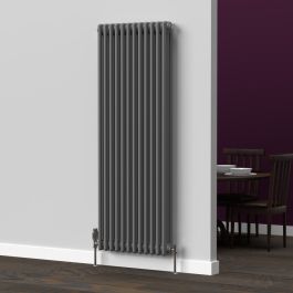 A 1500mm x 560mm 3-Column vertical radiator in an anthracite finish with chrome valves within a kitchen/dining room setting.