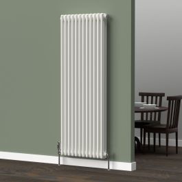 A 1500mm x 560mm 3-Column vertical radiator in a white finish with chrome valves within a kitchen/dining room setting.
