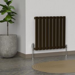 A 600mm x 630mm Horizontal Flat Single Radiator in an Antique Brass finish with chrome valves within a living room setting.
