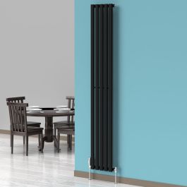 A 1800mm x 300mm Vertical Oval Radiator in a Space Black finish with chrome valves within a dining room setting.