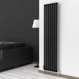 A 1800mm x 420mm Vertical Single Oval Radiator in a Space Black finish with chrome valves within a living room setting.
