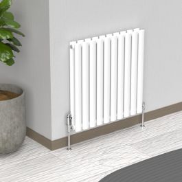 A 600mm x 540mm Horizontal Oval Double Radiator in a White finish with chrome valves within a living room setting.
