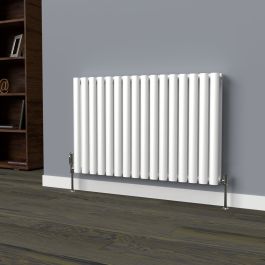 A 600mm x 960mm horizontal oval radiator in an White finish with chrome valves within a living room setting.
