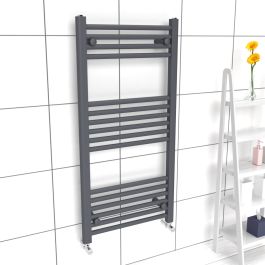 A 1000mm x 500mm 22mm Towel Radiator in an Anthracite finish with chrome manual  valves within a bathroom setting.
